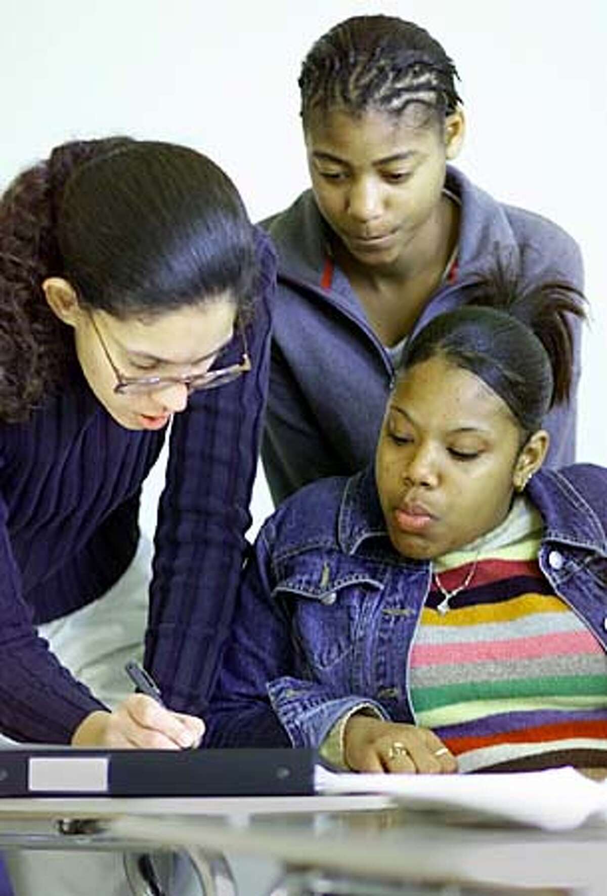 Teacher Katrina Scott-George (left) reviewed some math with students Alana Banks (center) and Katrina Nichols. Chronicle photo by Michael Maloney
