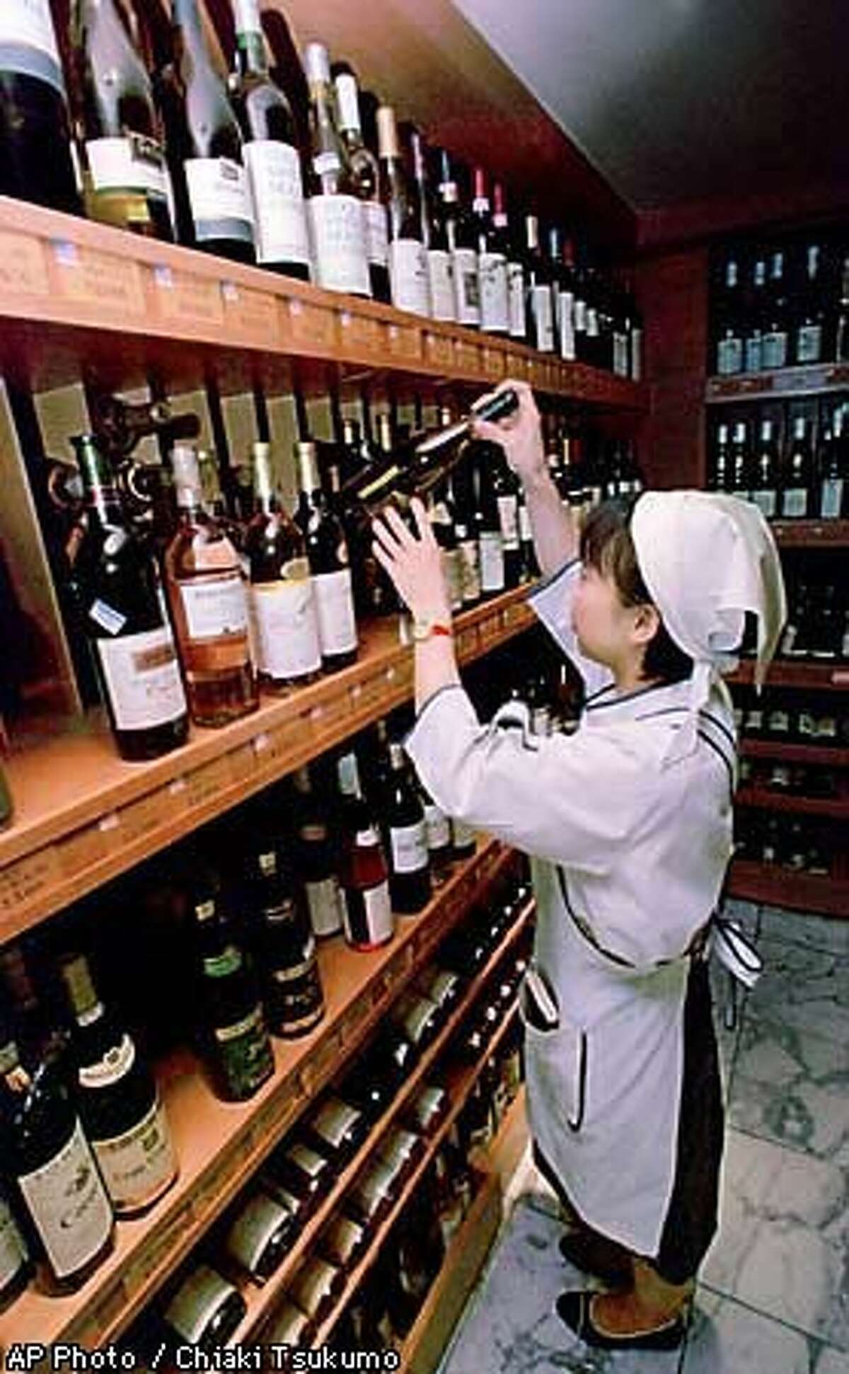 A sales clerk checked bottles of California wine in a Tokyo department store. Associated Press Photo by Chiaki Tsukumo
