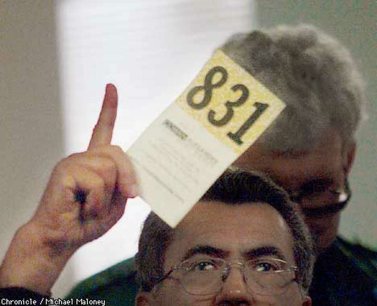 A buyer flashes his card to bid on an item. Cowan Alexander Equipment Group specializes in liquidating assets of failed dot com companies. This auction held in San Ramon was liquidating computer related items from two companies. CHRONICLE PHOTO BY MICHAEL MALONEY