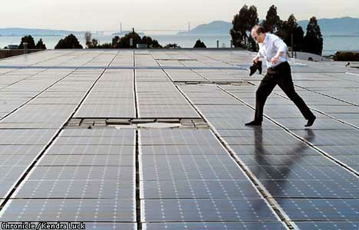 Daniel Shugar, Executive Vice President of PowerLight Corporation in Berkeley gingerly walks across solar panels on the roof of their manufacturing plant. The produce solar panels for industrial buildings, both queries and sales are up with the current energy crunch. (KENDRA LUCK/SAN FRANCISCO CHRONICLE)
