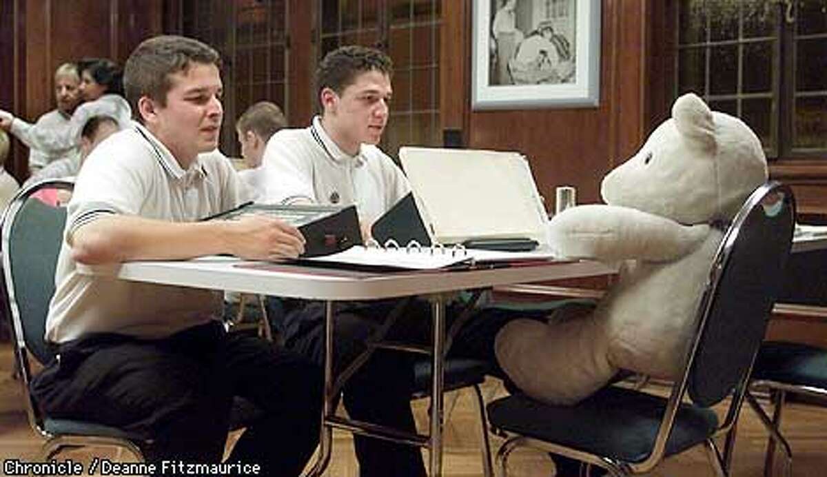 (l to r) Joe Schwaartz, 28, and Gabe Matoya, 20, use a teddy bear as a stand-in as they learn to use an e-meter which purports to measure thoughts as part of their Scientology training at the training center at American St. Hill Organization, the Scientology headquarters in Los Angeles. CHRONICLE PHOTO BY DEANNE FITZMAURICE
