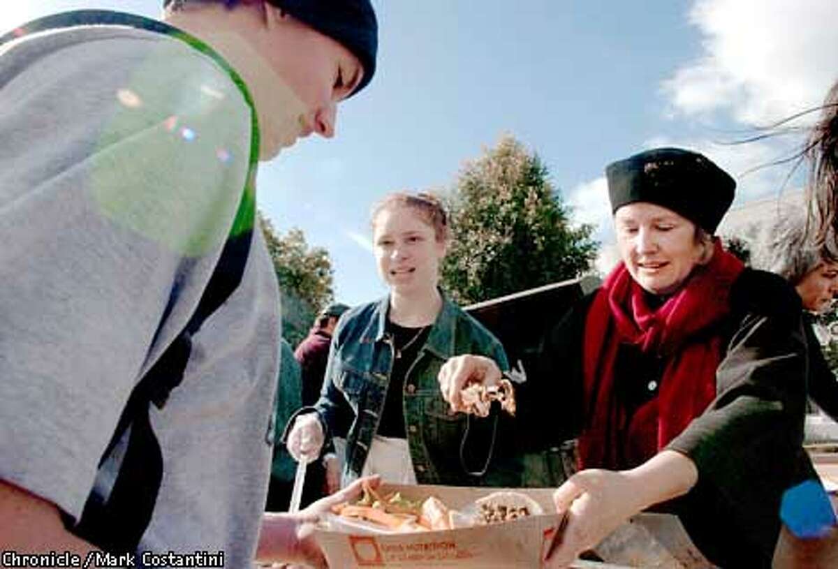 FOOD07a-C-6FEB01-EZ-MC. Alice Waters(right) and Berkeley High sophomore Maliyah Coye(middle) serve Chez Panisse pork tacos at Berkekely High School students as part of the school's introduction to its new food court . Photo: Mark Costantini /The Chronicle