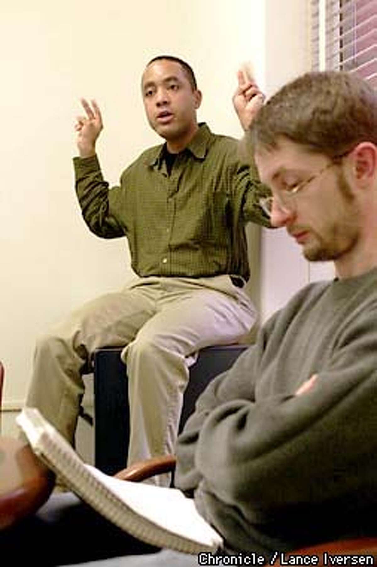 UC Berkekey Professor John McWhoter outlines his language class as Josef Ruppenhofer looks over his notes.McWhorter is the author of a new controversial book " Losing the race : self sabotage in Black America Because he's black and anti-affirmative action. By LANCE IVERSEN/SAN FRANCISCO CHRONICLE