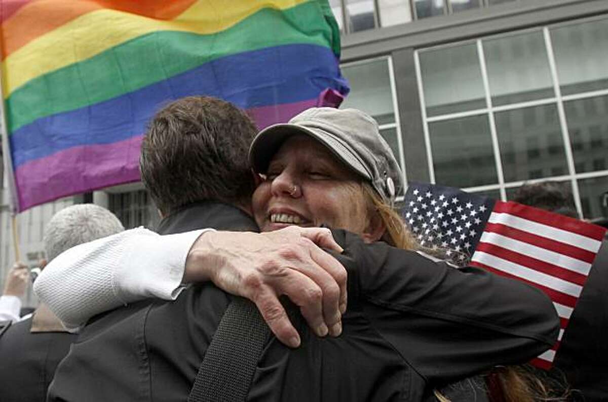 Sheree Red Bornand, right, hugs Aidan Dunn after hearing the decision in the United States District Court proceedings challenging Proposition 8 outside of the Phillip Burton Federal Building in San Francisco, Wednesday, Aug. 4, 2010. A person close to thecase says a federal judge has overturned California's same-sex marriage ban in a landmark case that could eventually land before the U.S. Supreme Court. Chief U.S. District Judge Vaughn Walker made his ruling Wednesday in a lawsuit filed by two gay couples who claimed the voter-approved ban violated their civil rights.