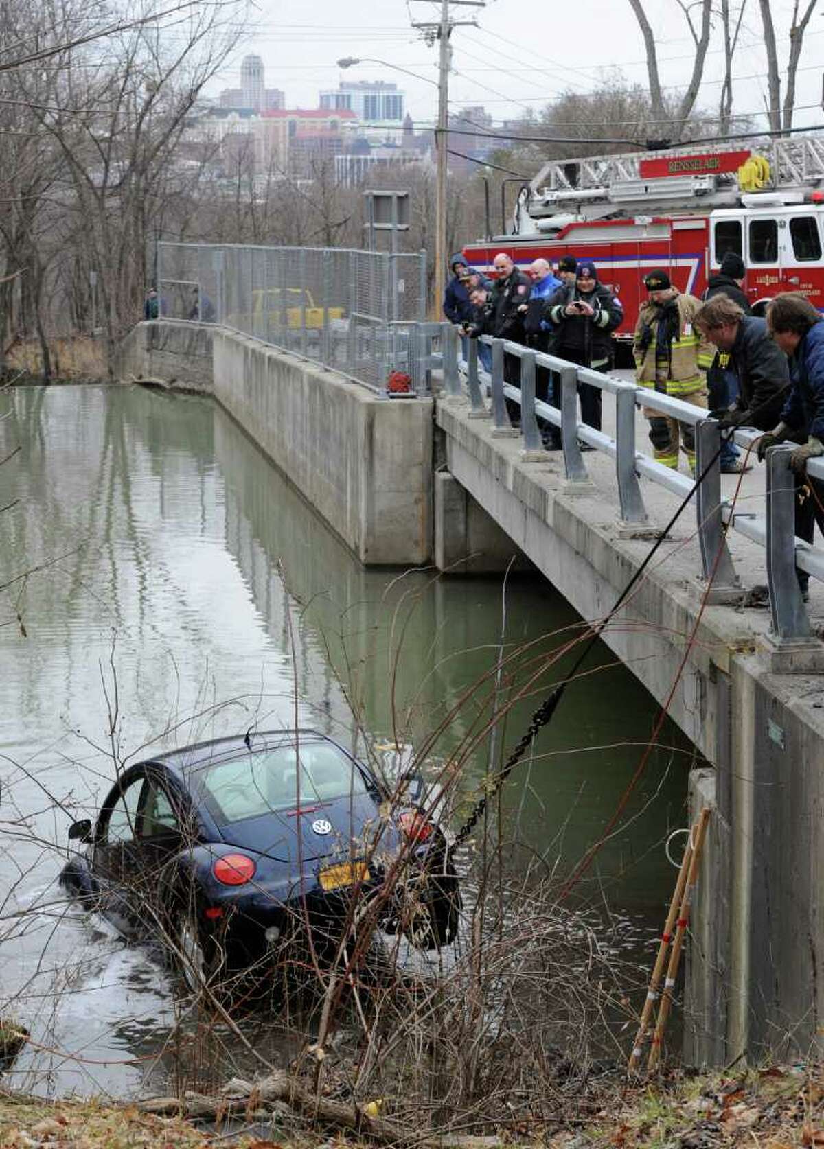 Members of the Clinton Heights Fire Department Rescue Squad work to remove a Volkswagen bug from the depths of the Red Mill Creek in Rensselaer, N.Y. Feb. 2, 2012. Geist towing was used to winch the vehicle from the creek. (Skip Dickstein / Times Union)