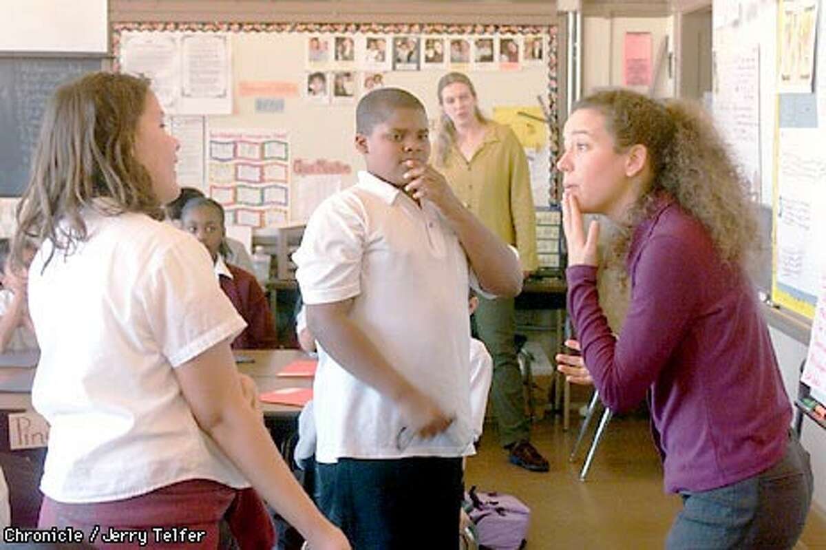 Britt Aageson, right, and Christine Young conduct an exercise at James Denman Middle School with sixth graders Sarah Stevenson and Brandon Smith as part of the Streetside program. Chronicle photo by Jerry Telfer