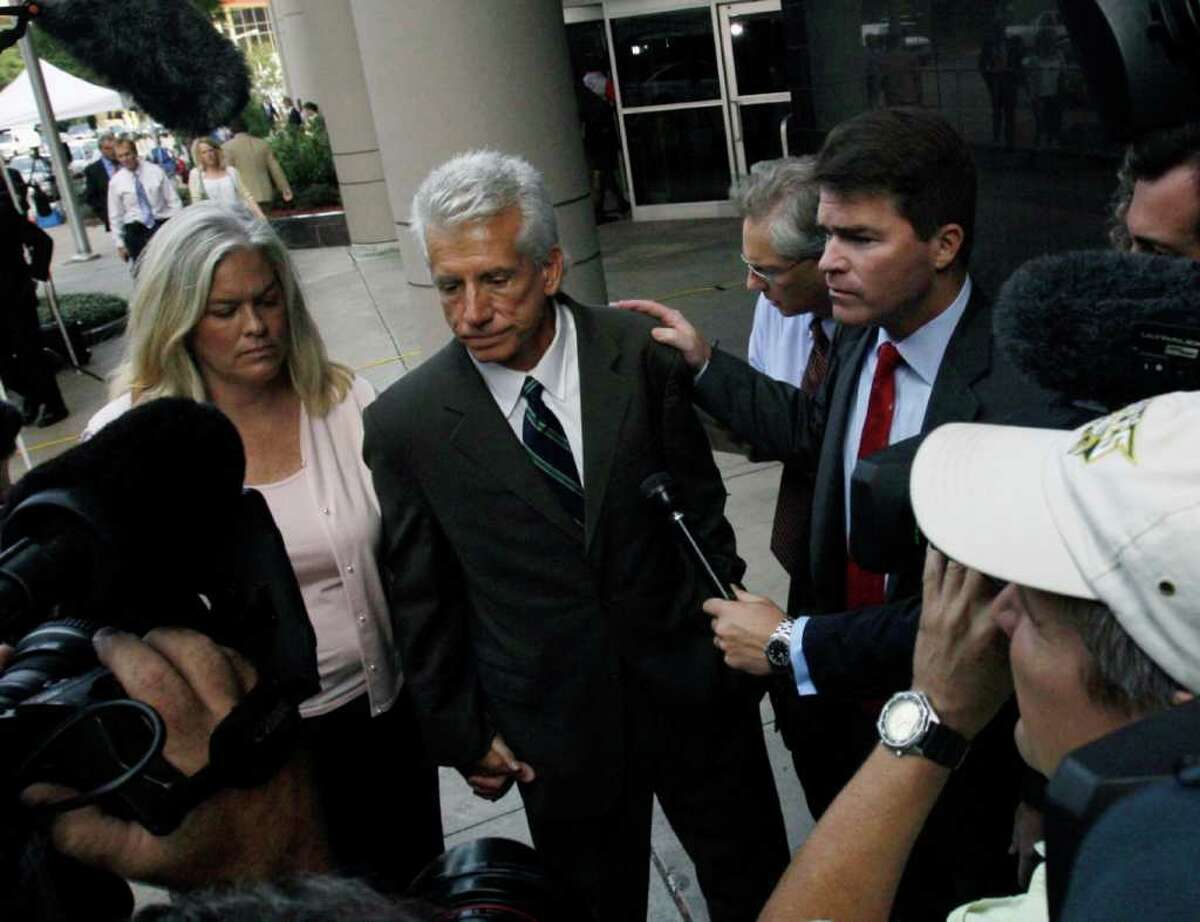 Stanford Financial Group's former finance chief, James. M. Davis, center, and his attorney David Finn are surrounded by media as they leave the federal courthouse after pleading guilty to three counts: conspiracy to commit mail, wire and securities fraud; mail fraud and conspiracy to obstruct a Securities and Exchange Commission investigation Thursday, Aug. 27, 2009 in Houston.