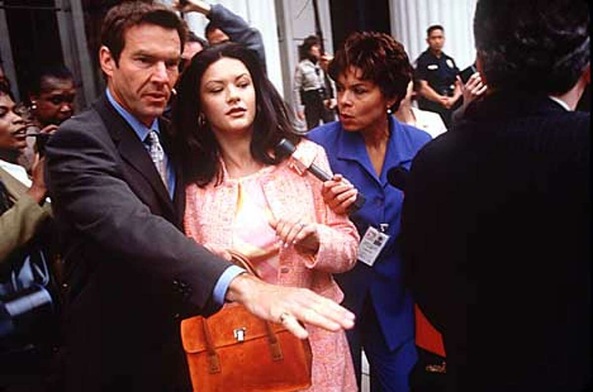 Catherine Zeta-Jones, with her attorney (Dennis Quaid), is a drug lord's wife trying to keep her husband out of jail. Publicity photo