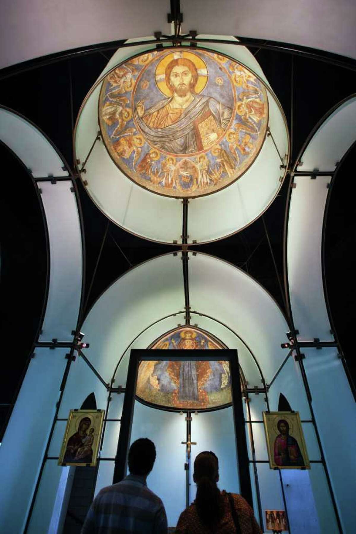 The Lysi dome, top, and a fresco showing the Virgin, flanked by archangels Gabirel and Michael, bottom, are seen in the Byzantine Fresco Chapel on Friday, Sept. 23, 2011, in Houston. For more than two decades Houston has been home to a restored pair of large 13th-century Byzantine frescoes that Menil Collection founder Dominique de Menil purchased from art thieves in 1984. Now the Menil is working to return them to their rightful owner, the Holy Archbishopric of Cyprus. While the move seemingly recalls recent decisions by New York's Metropolitan Museum of Art and others to return priceless artworks that improperly left their countries of origin, there's a difference: Neither de Menil nor the museum she founded ever claimed to own the frescoes. ( Smiley N. Pool / Houston Chronicle )