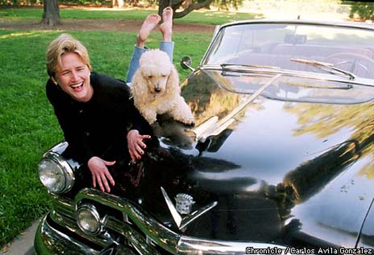 Mary Bartnikowski, author of the book, "Everyday Naked," sits on her 1950 Cadillac with Fluffy, her family's poodle. Bartnikowski has been compared to Erma Bombeck in her story-telling ability and the comical approach to everyday life's trials and tribulations. (CHRONICLE PHOTO BY CARLOS AVILA GONZALEZ)