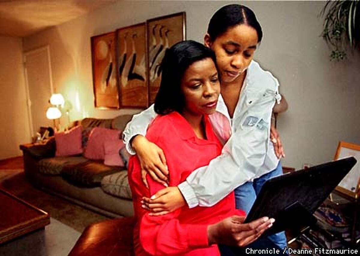 Gwen Clark gets a hug from her daughter, Clarissa, 15, who just walked in from school. Gwen is holding a photo of her other daughter, Toni, who disappeared after her car broke down on the Bay Bridge about eight years ago. Toni would be 26 years old now. CHRONICLE PHOTO BY DEANNE FITZMAURICE