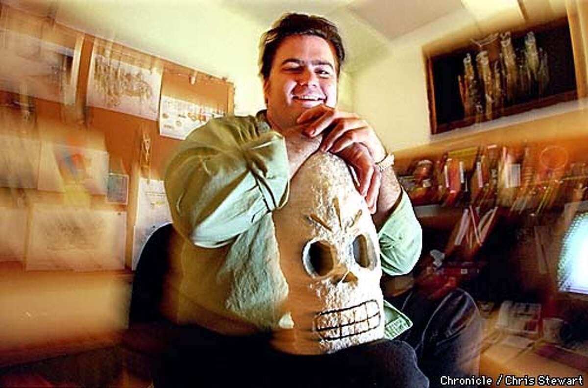 Tim Schafer, game designer for LucasArts in San Rafael, poses with a skull from his latest game, "Grim Fandango." Schafer is photographed in his office at LucasArts, 1600 Los Gamos Drive. BY CHRIS STEWART/THE CHRONICLE