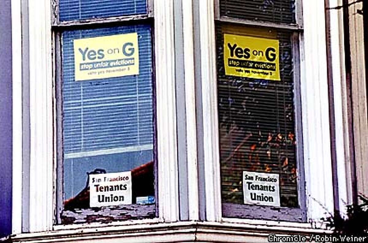 Two signs supporting Proposition G, a tenant-sponsored measure that would permanently and severly limit owner move-in evictions and end tenancies-in-common, a technique used by renters to buy buildings but that also shrinks the available pool of rental units, hang on windows of the San Francisco Tenants Union in the Mission neighborhood. BY ROBIN WEINER/THE CHRONICLE