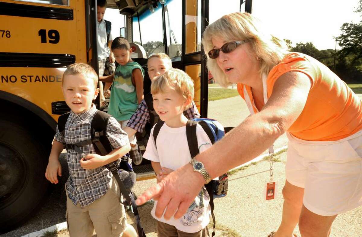Para-educator Lori Corsak directs returning students entering John Pettibone School in New Milford for the first day of classes on Aug.26, 2009.