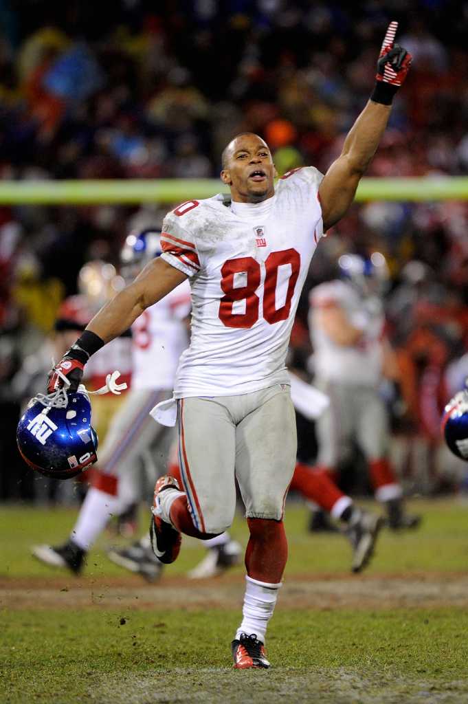 New York Giants - Super Bowl Football New York Giants wide receiver Victor  Cruz (80) holds the Vince Lombardi Trophy during the Super Bowl XLVl  football game against the New England Patriots