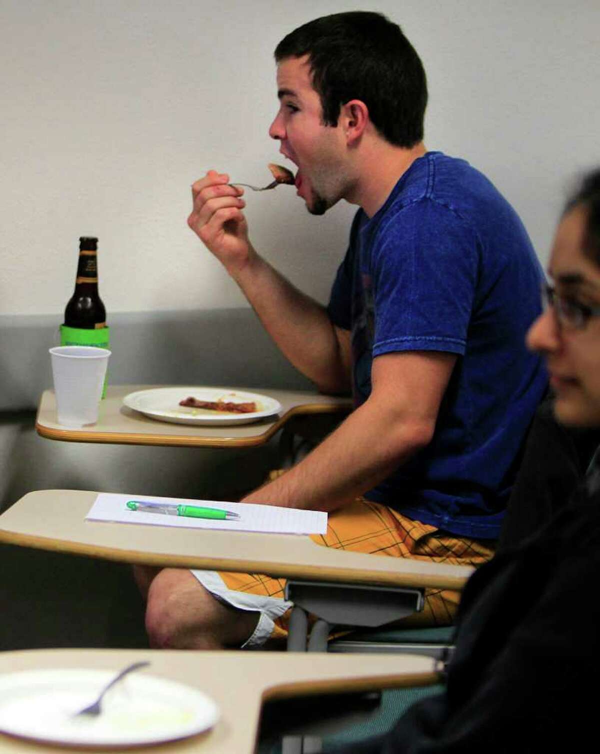 Jonathan Hammann, 21, eats barbecue and drinks a beer in "Kickin' It in Small Town Texas" a Rice University class that looks at life "beyond the hedges."