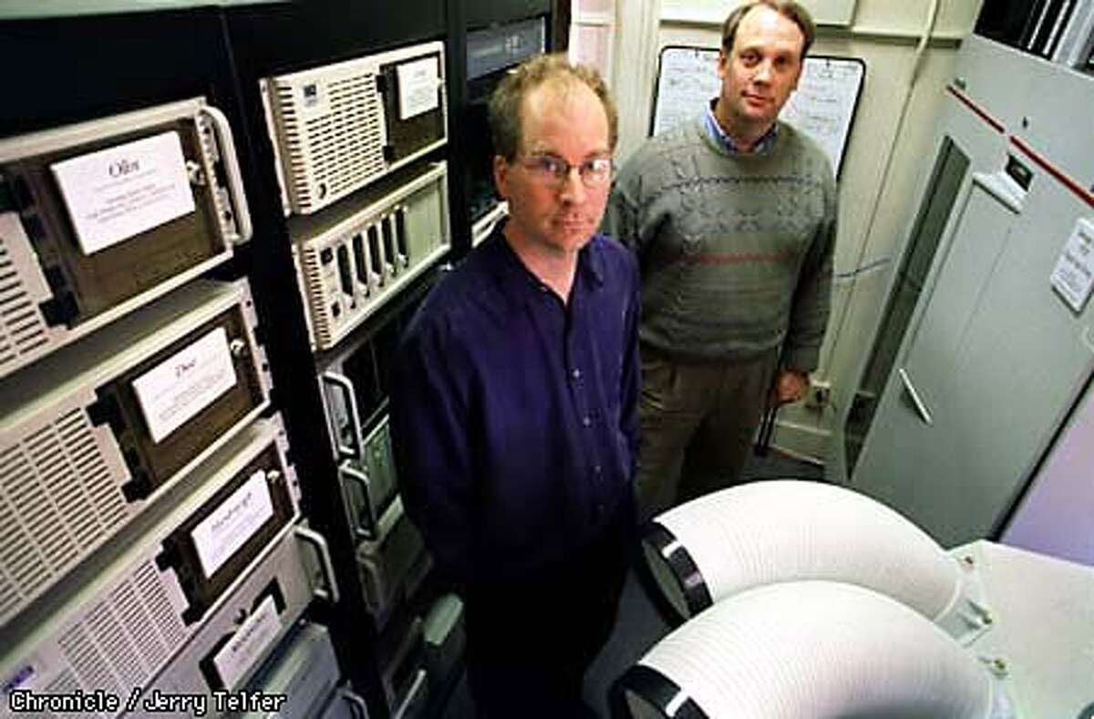 ALEXA/C/06MAY98/BU/JLT Alexa Internet co-founders Brewster Kahle (left) and Bruce Gilliat (both cq) amid the hardware their firm uses to archive the entire World Wide Web and provide a searchable database. The archive contains every web page since 1996, and currently requires 10 terabytes of storage space. SF Presidio - Bldg. 37 PHOTO BY JERRY TELFER