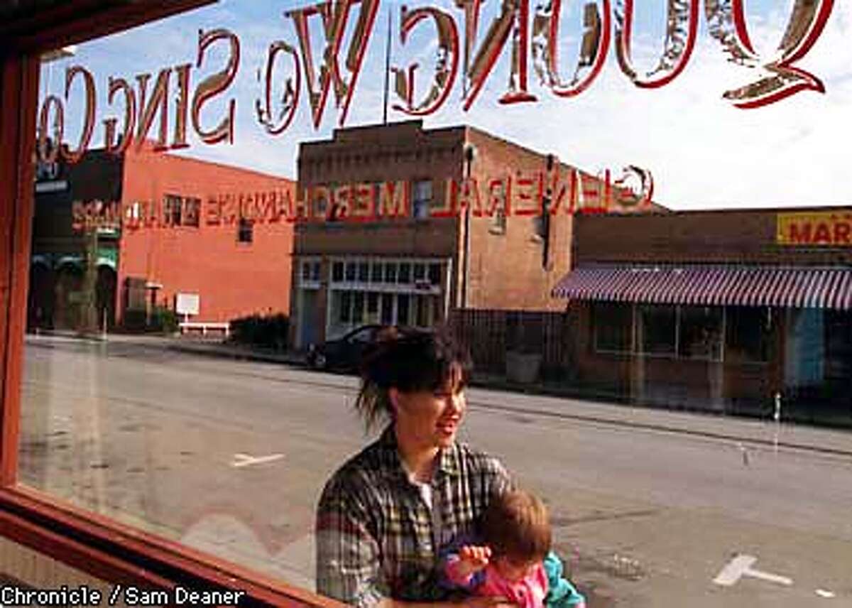 Outside Quong Wo Sing Company in Islelton Kristin Chinn-Rhodes holding one-year-old Payton proudly speaks about her deceased grandmother, Bessie Chinn, who started the Isleton Chinese New Year celebration in 1984 as a casual celebration. Chinn-Rhodes hopes to reopen Quong Wo Sing Company which has been in her family since 1885. (Chronicle Photo by Sam Deaner)