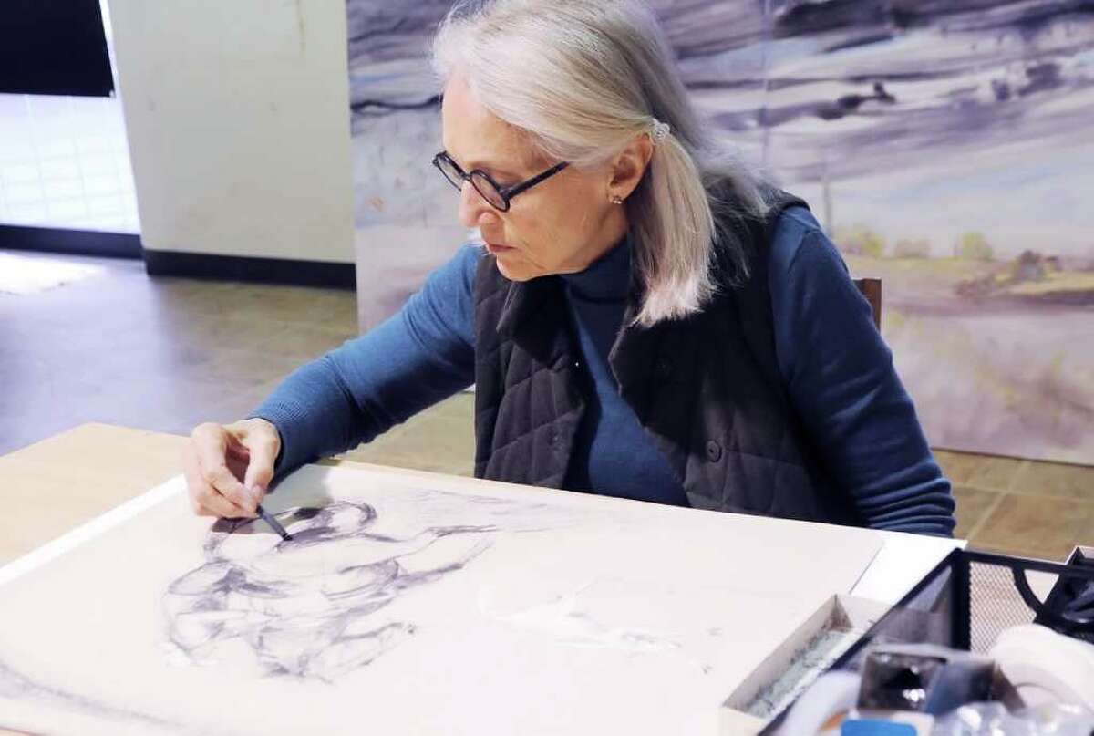 Greenwich artist Marian "Bing" Bingham paints in her studio Thursday, Jan. 19, 2012. She is awaiting the return of several of her paintings, which were seized a few months ago along the Serbian border en route to a European exhibition.