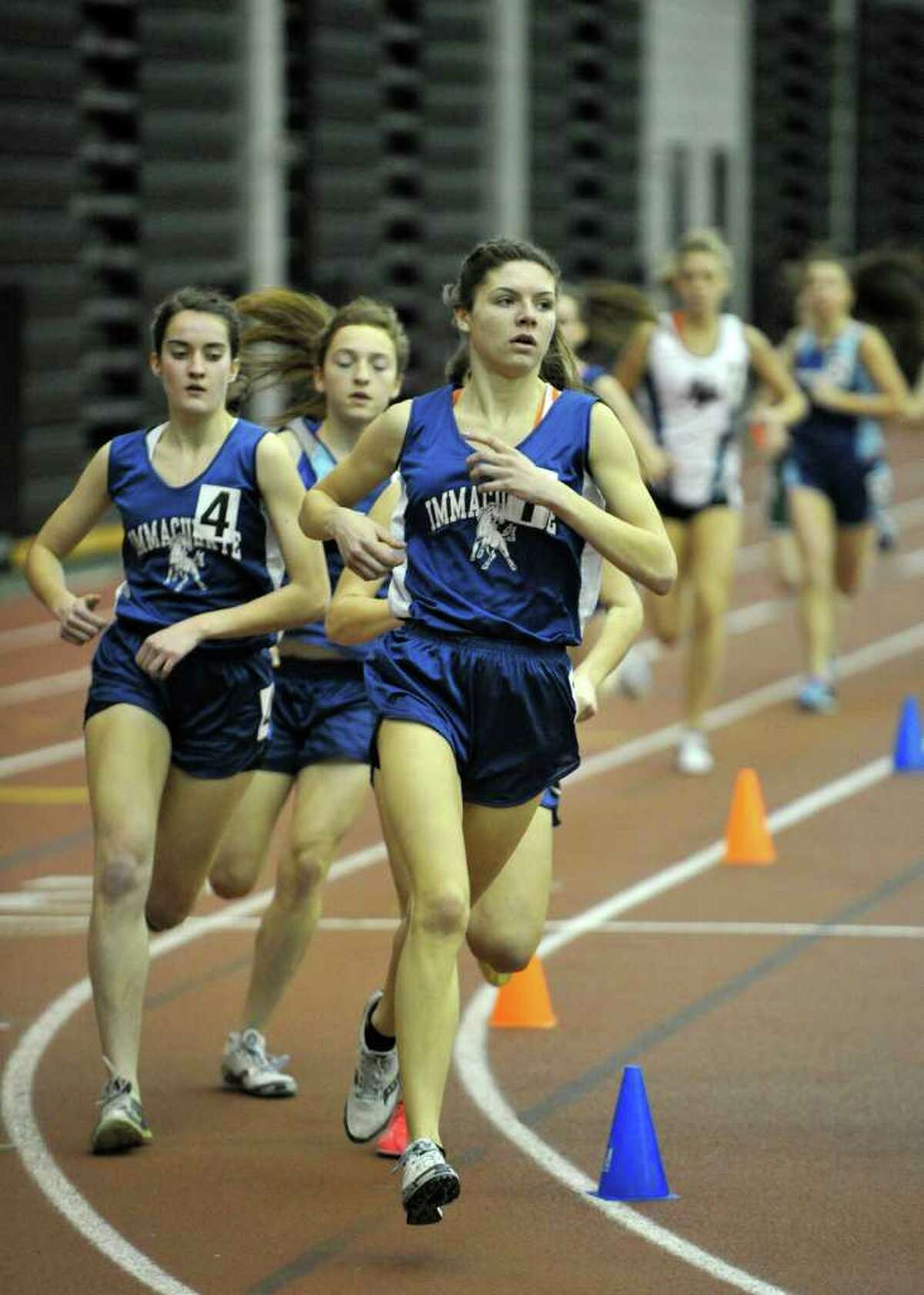 Immaculate's Maggie Christe leads the pack in the 1600-meter-run during the SWC indoor track and field championships at Hillhouse High School in New Haven on Saturday, Feb. 4, 2012. Christe set the SWC championship record for the 1600 meter-run.