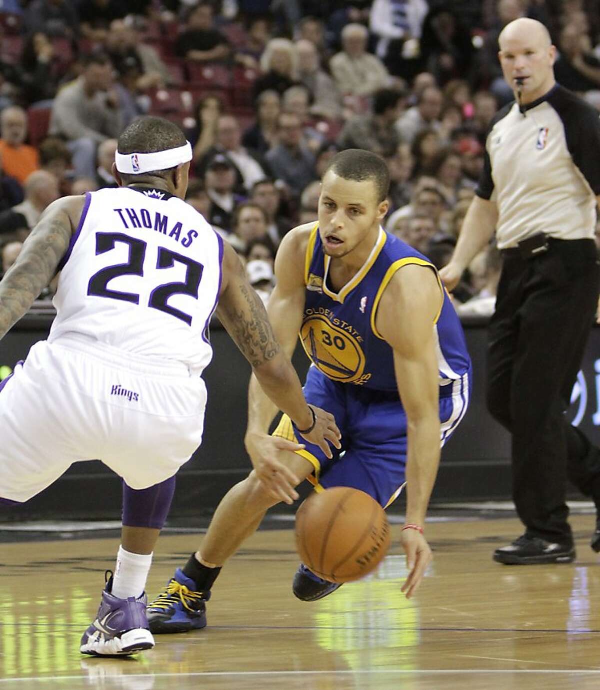 Golden State Warriors guard Stephen Curry, right, eludes Sacramento Kings guard Isaiah Thomas during the second quarter of an NBA basketball game in Sacramento, Calif., Saturday, Feb. 4, 2012. (AP Photo/Rich Pedroncelli)