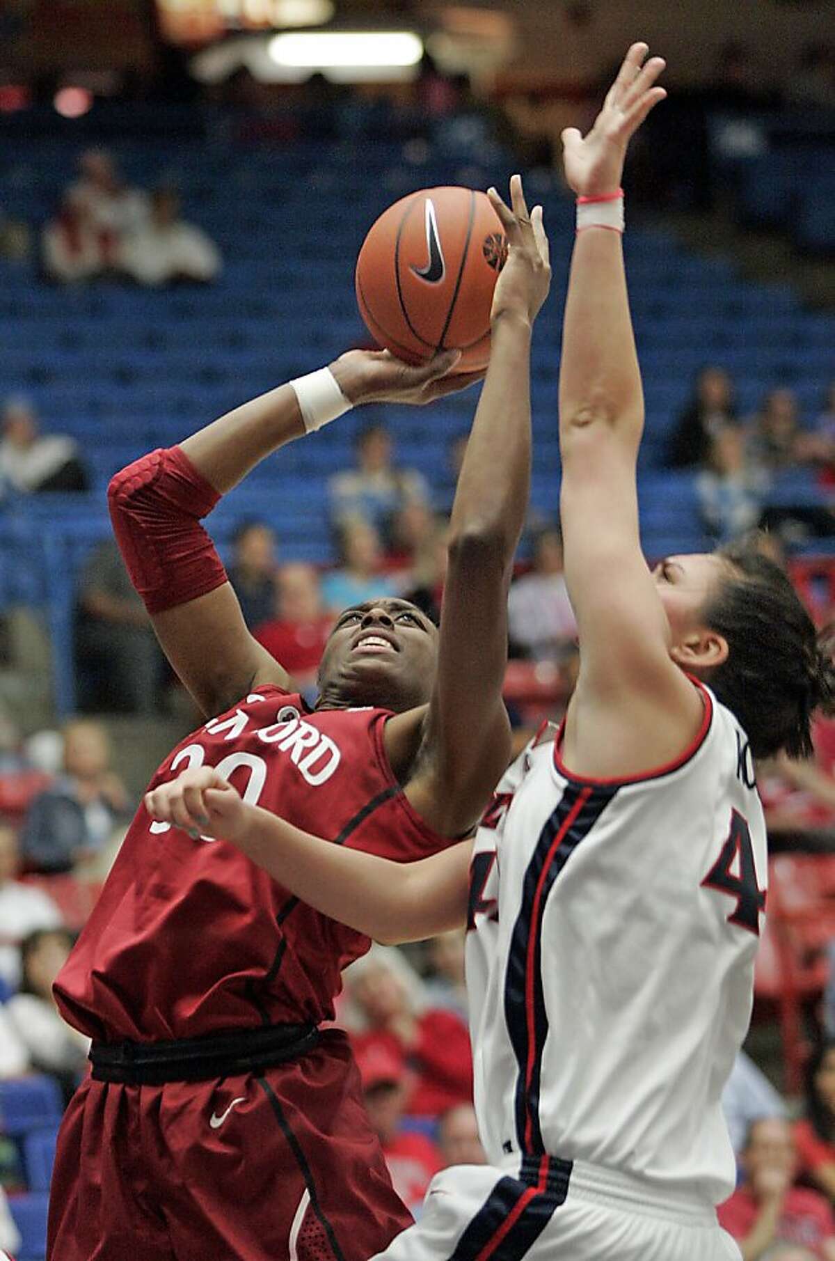 Stanford's Nnemkadi Ogwumike (30) shoots for two over the defense of Arizona's Aley Rohde (44) during the second half of an NCAA college basketball game at McKale Center in Tucson, Ariz., Saturday, Feb. 4, 2012. Stanford won 91-51. (AP Photo/John Miller)