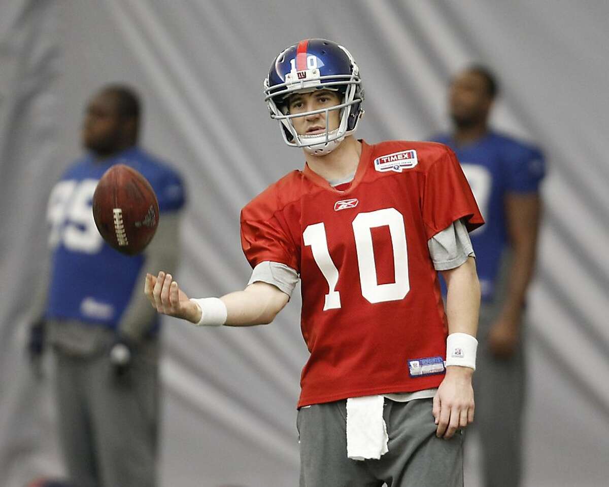 New York Giants' Eli Manning tosses a ball during practice, Thursday, Feb. 2, 2012, in Indianapolis. The Giants will face the New England Patriots in the NFL football Super Bowl XLVI on Feb. 5.