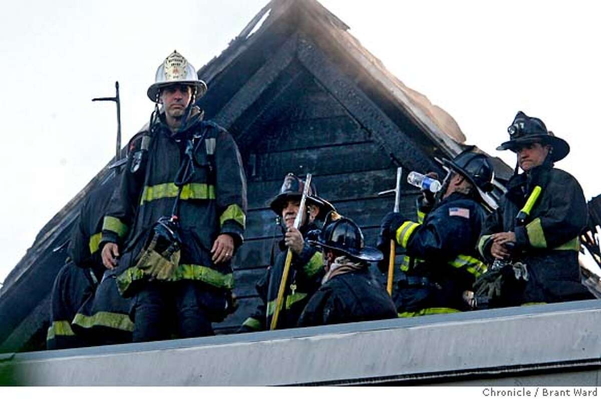 Firemen stood atop the apartment building on Noe Street which sustained damage to the upper apartments. Two elderly people were taken away by ambulance, but were not harmed in the fire. A three alarm fire near the corner of Noe and 17th Street woke up this residential area in San Francisco during the evening commute. {By Brant Ward/San Francisco Chronicle}8/14/07