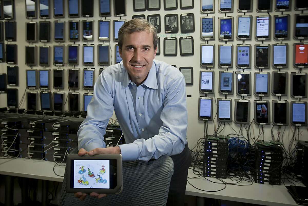 William Lynch, chief executive of Barnes & Noble, with a wall full of e-readers at a company site, where 300 employees are aiming to build the company's digital side, in Palo Alto, Calif., Jan. 24, 2012. Barnes & Noble, once viewed as the brutal capitalist of the book trade, isn't expected to disappear overnight, but there is worry that it might slowly wither as readers embrace e-books. (Peter DaSilva/The New York Times) -- PHOTO MOVED IN ADVANCE AND NOT FOR USE - ONLINE OR IN PRINT - BEFORE JAN. 29, 2012.