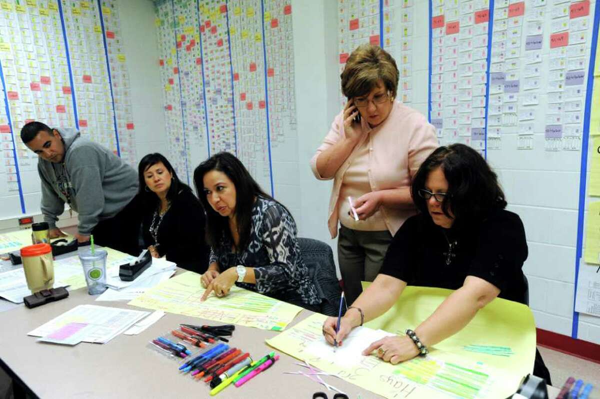 Roosevelt Elementary School principal Pamela Reece, second from right, converses with third grade teachers, from left, Isaac Gomez, Melissa Castillo, Ernestina Mendez and Star Hays in the school's War Room on Jan. 17, 2012.