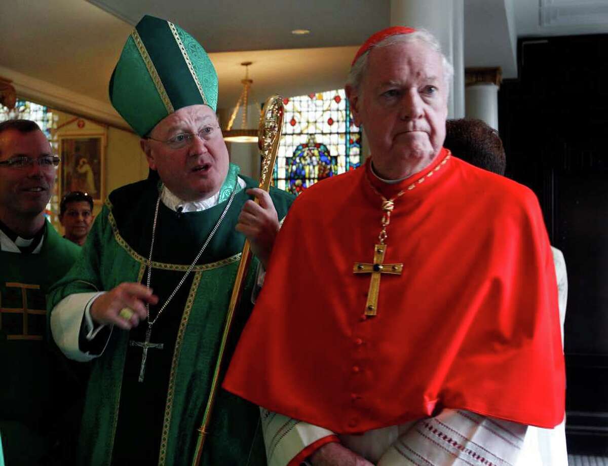 In this Sept. 11, 2011 file photo, Archbishop Timothy Dolan, left, and Cardinal Edward Egan, former archbishop of New York, stand together at St. Peter's Roman Catholic Church in Lower Manhattan before a holding a service to commemorate the 10th anniversary of the terrorist attacks on the World Trade Center. In the recent edition of Connecticut Magazine Egan claims that while bishop in Bridgeport, Conn. he did nothing wrong regarding abuse allegation against priests in the diocese and in fact never had a case of alleged abuse while he was bishop. In the interview Egan also expressed regret for the apology he made regarding the priest scandal here. (AP Photo/Mel Evans, File)