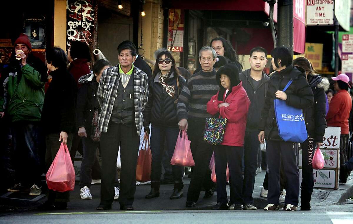 San Francisco China Town shoppers fill their bags as they roam through the business district Tuesday December 6, 2011. San Francisco Board of Supervisors voted Tuesday on whether to make stores and restaurants start charging customers 10 cents for every bag handed out at the checkout counter. Exceptions will be made for frozen food, meat and fish, flowers and plants, unwrapped prepared foods or bakery goods. Otherwise, bags for everything else, from a carton of milk to a paperback book, will start costing.