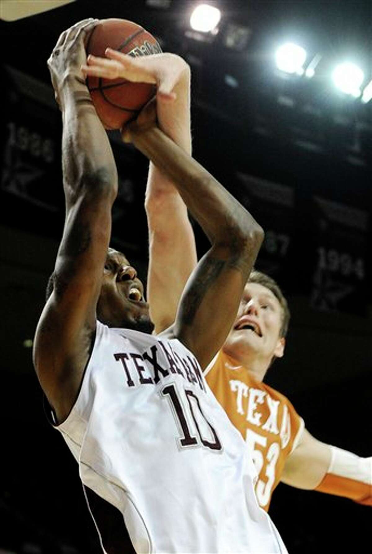 Texas A&M's David Loubeau (10) is fouled by Texas' Clint Chapman (53) in the first half of an NCAA college basketball game Monday, Feb. 6, 2012, in College Station, Texas. (AP Photo/Pat Sullivan)