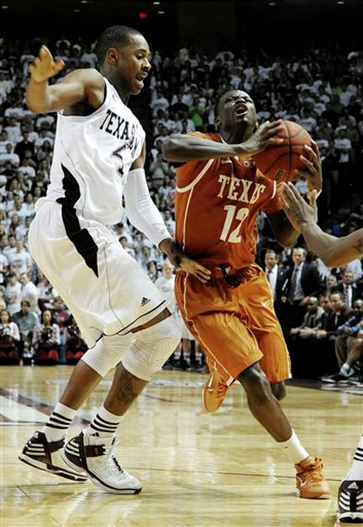 Texas' Myck Kabongo (12) works against Texas A&M's Keith Davis (4) in the second half of an NCAA college basketball game Monday, Feb. 6, 2012, in College Station, Texas. Texas won 70-68. (AP Photo/Pat Sullivan)
