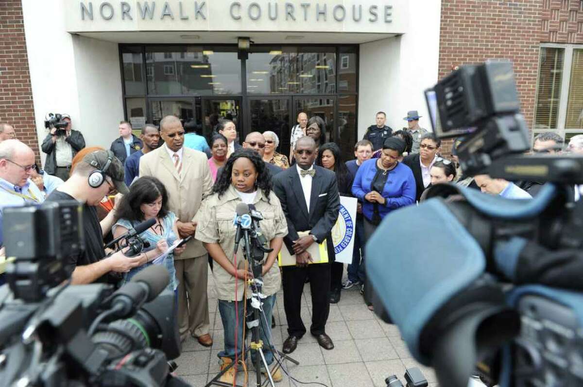 Tanya McDowell speaks reporters, with Jack Bryant of the Stamford NAACP, left, and attorney Darnell Crosland, right, before her arraignment in state Superior Court in Norwalk Wednesday on larceny charges. McDowell allegedly used a false Norwalk address to enroll her son in school.