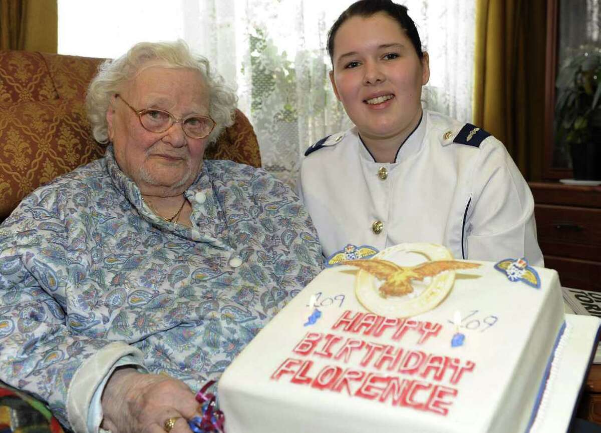 Florence Green is presented with a cake on her 109th birthday last Feb. 19 at her home in King’s Lynn, England, by Hannah Shaw of the Royal Air Force. Green, who died Saturday, joined the RAF as a teenager shortly before World War I ended. She worked in an officers’ mess on the home front, serving meals and tea.