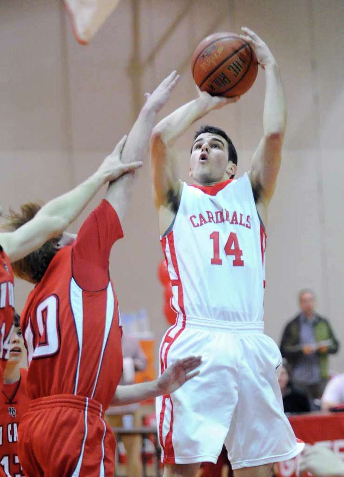 At right, Alejandro Rodriguez # 14 of Greenwich High School hits on a short jumper during boys high school basketball between Greenwich High School and New Canaan High School at Greenwich, Tuesday night, Feb. 7, 2012.