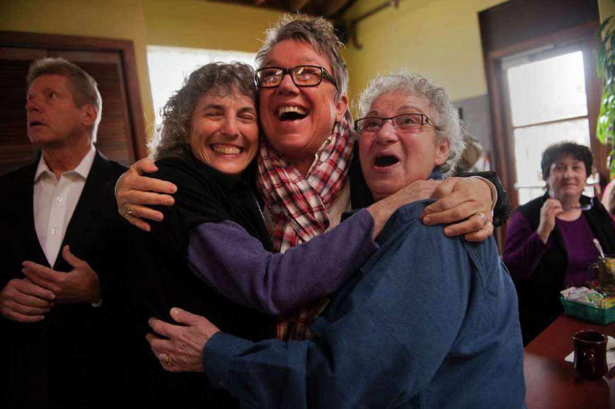 Partners Ellen Pontac, left, and Shelly Bailes, right, hug Tina Reynolds, on news of the ruling Tuesday.