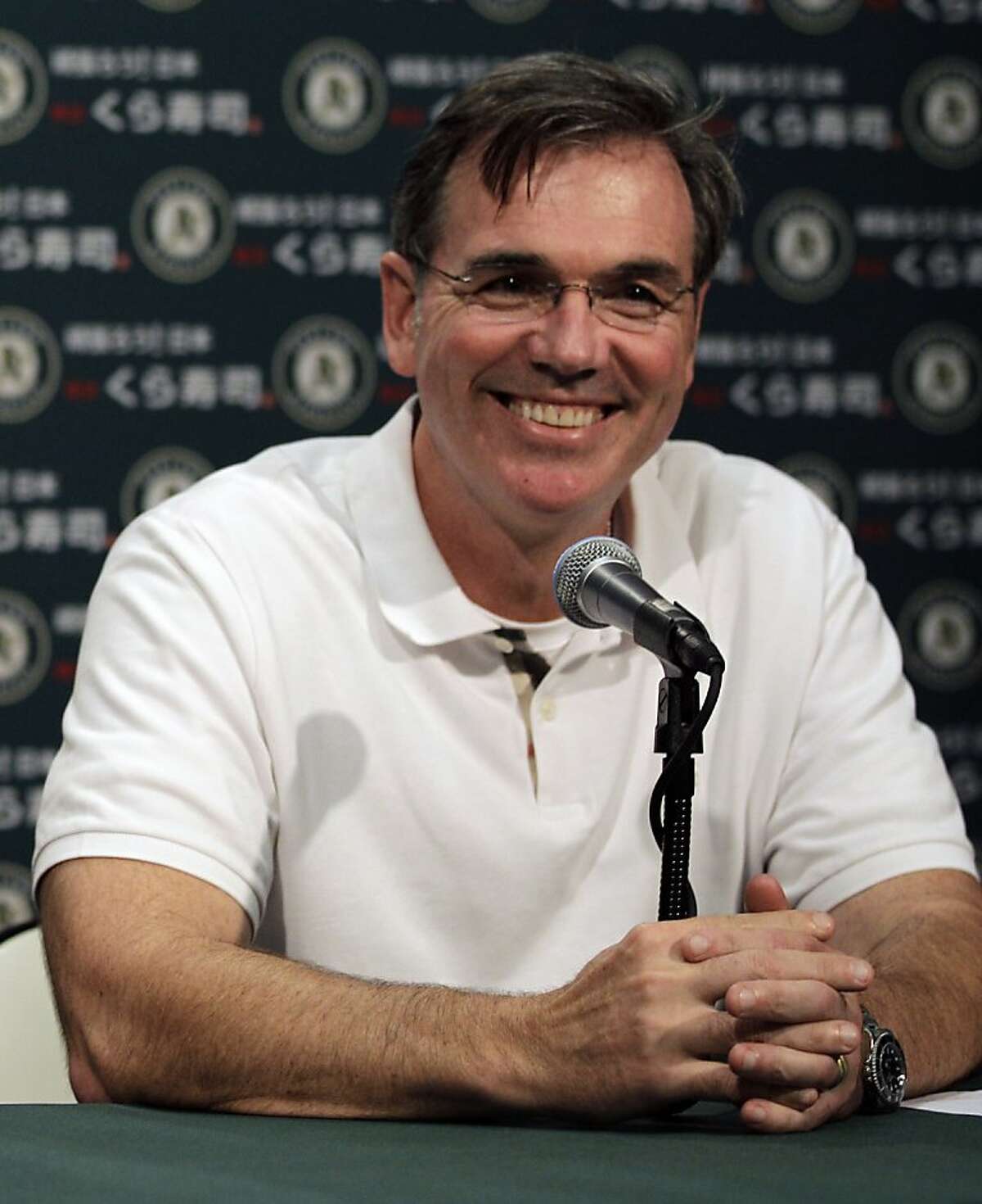 Oakland Athletics general manager Billy Beane smiles during a media conference Wednesday, Sept. 21, 2011, in Oakland, Calif. The Oakland Athletics have reached agreement on a three-year contract to keep Bob Melvin as their permanent manager. The 49-year-old Melvin took over in an interim capacity for the fired Bob Geren in June and has a 42-49 record after Tuesday night's 7-2 loss to the AL West-leading Texas Rangers at the Coliseum. Geren's dismissal marked the first time Oakland fired a manager during the season in a quarter century.