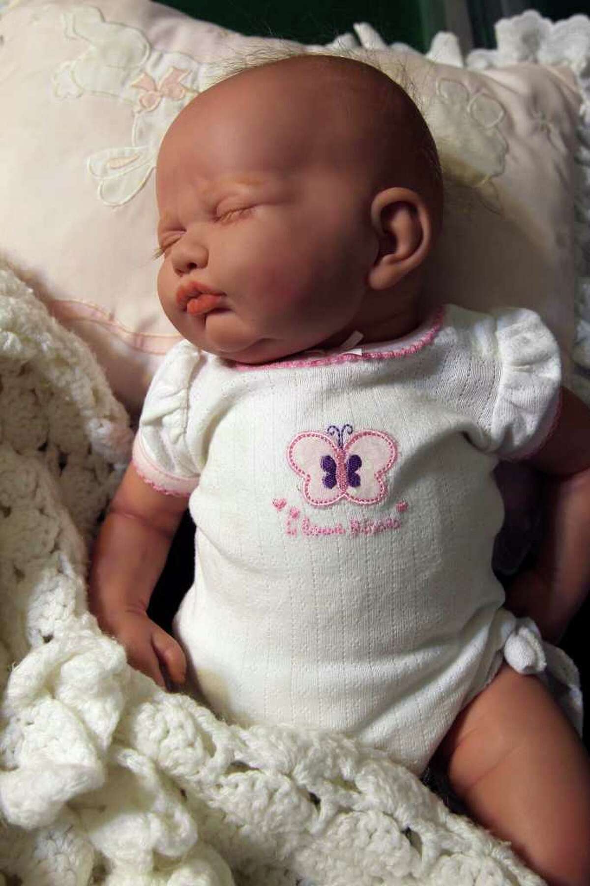 A “reborn” doll transformed by Tanya Sada looks like a real baby.