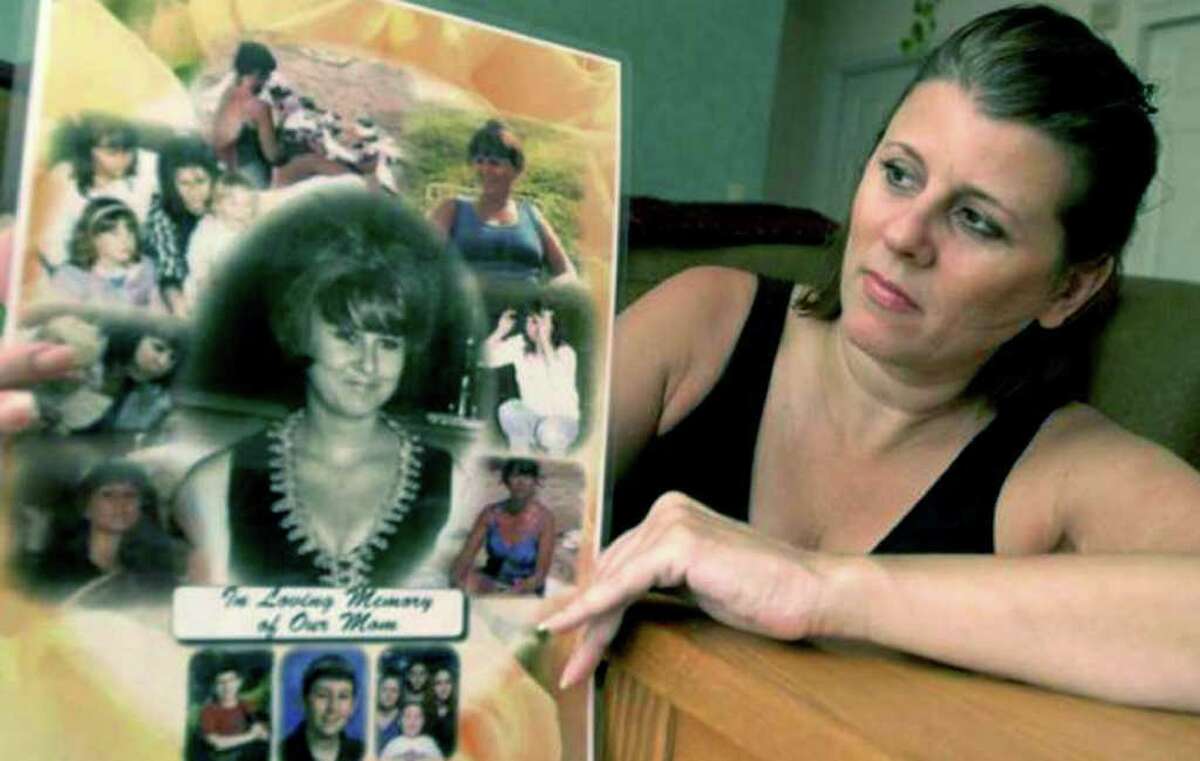 SPECTRUM/Sherrie Passaro of Danbury holds a poster of photographs in memory of her mother, Mary Badaracco, who disappeared from her Sherman home about 27 years ago. 2010