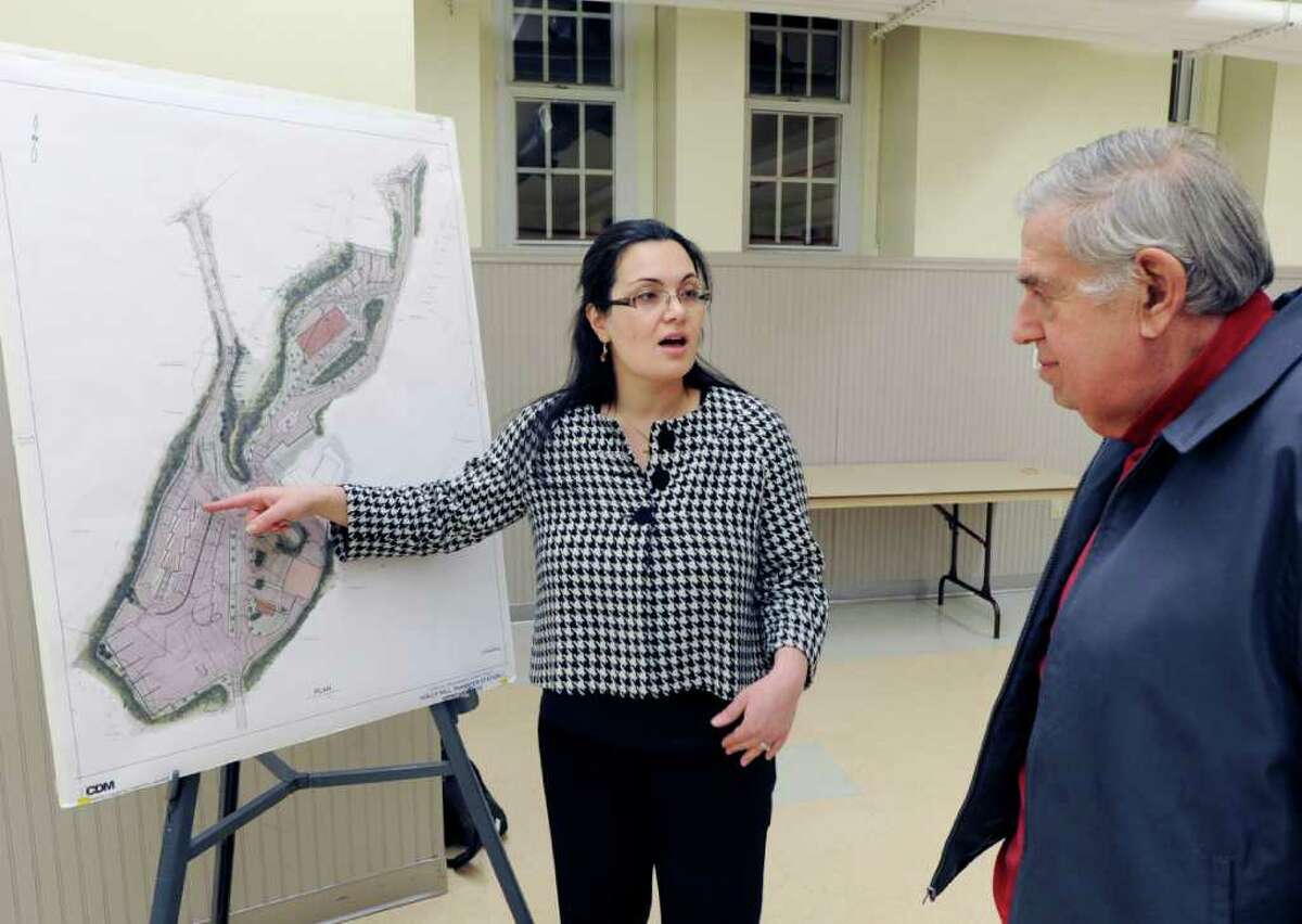 Gabriella Circosta-Cohee, left, a civil engineer with the Town of Greenwich, uses a rendering of the proposed changes to the Holly Hill Resource Recovery Facility while discussing those changes with Donald Vitti of Byram during a meeting at the Western Greenwich Civic Center Wednesday night, Feb. 8, 2012.