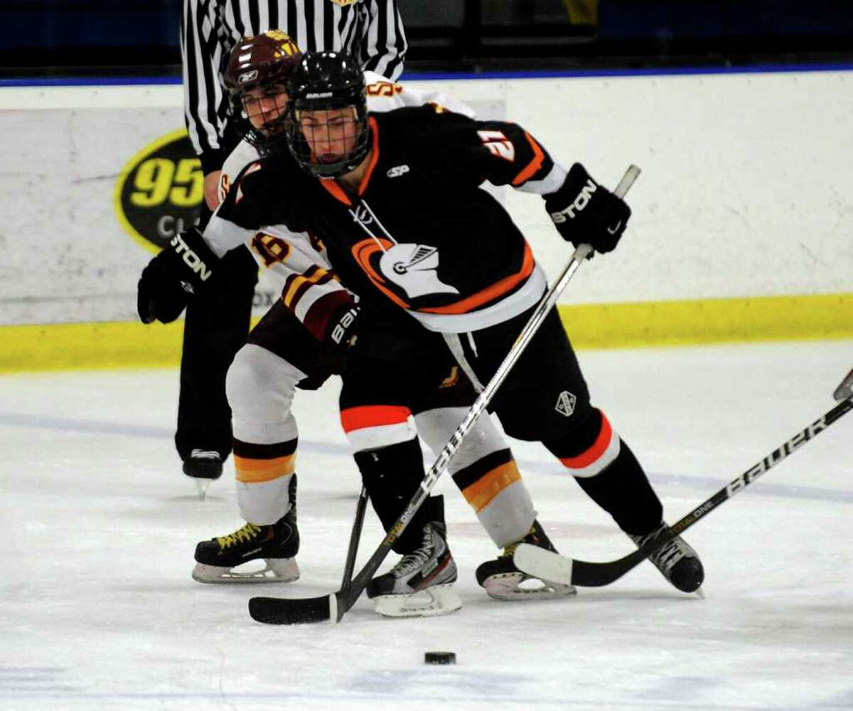 Stamford's #21 C.J. DelVaglio tries to fend off St. Joseph's #16 Matt Julian as they go for the puck, during boys hockey action in Shelton, Conn. on Wednesday February 8, 2012.