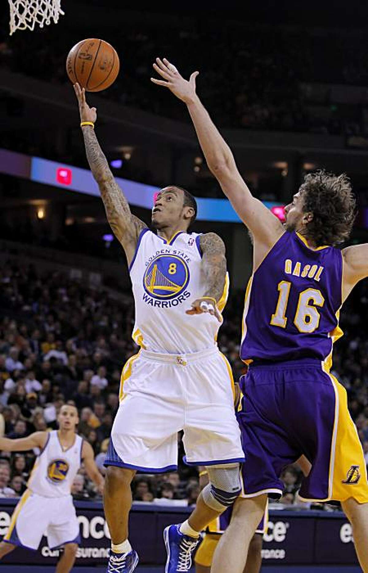 Monta Ellis puts up a shot as Pau Gasol tries to defend in the first quarter. The Warriors played the Los Angeles Lakers at Oracle Arena in Oakland, Calif., on Wednesday, January 12, 2011