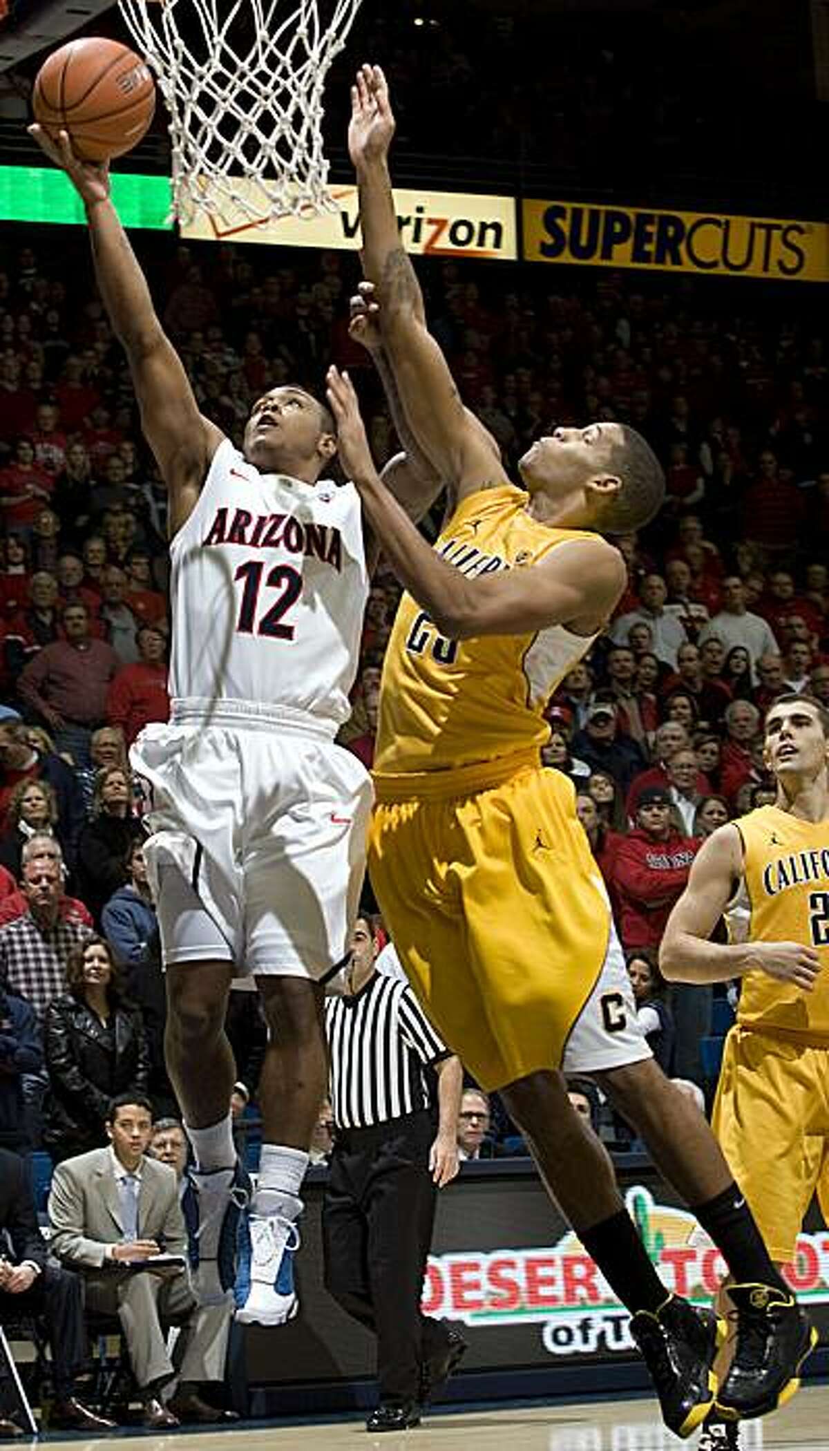 Arizona's Lamont Jones (12) shoots over California's Allen Crabbe (23) during the first half of an NCAA college basketball game at McKale Center in Tucson, Ariz., Thursday, Jan. 6, 2011.