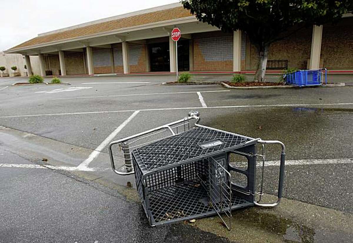 Shopping carts lie on their side in the abandoned parking lot in front of a shuttered Mervyn's department store in Dublin, Calif., on Saturday, May 2, 2009.