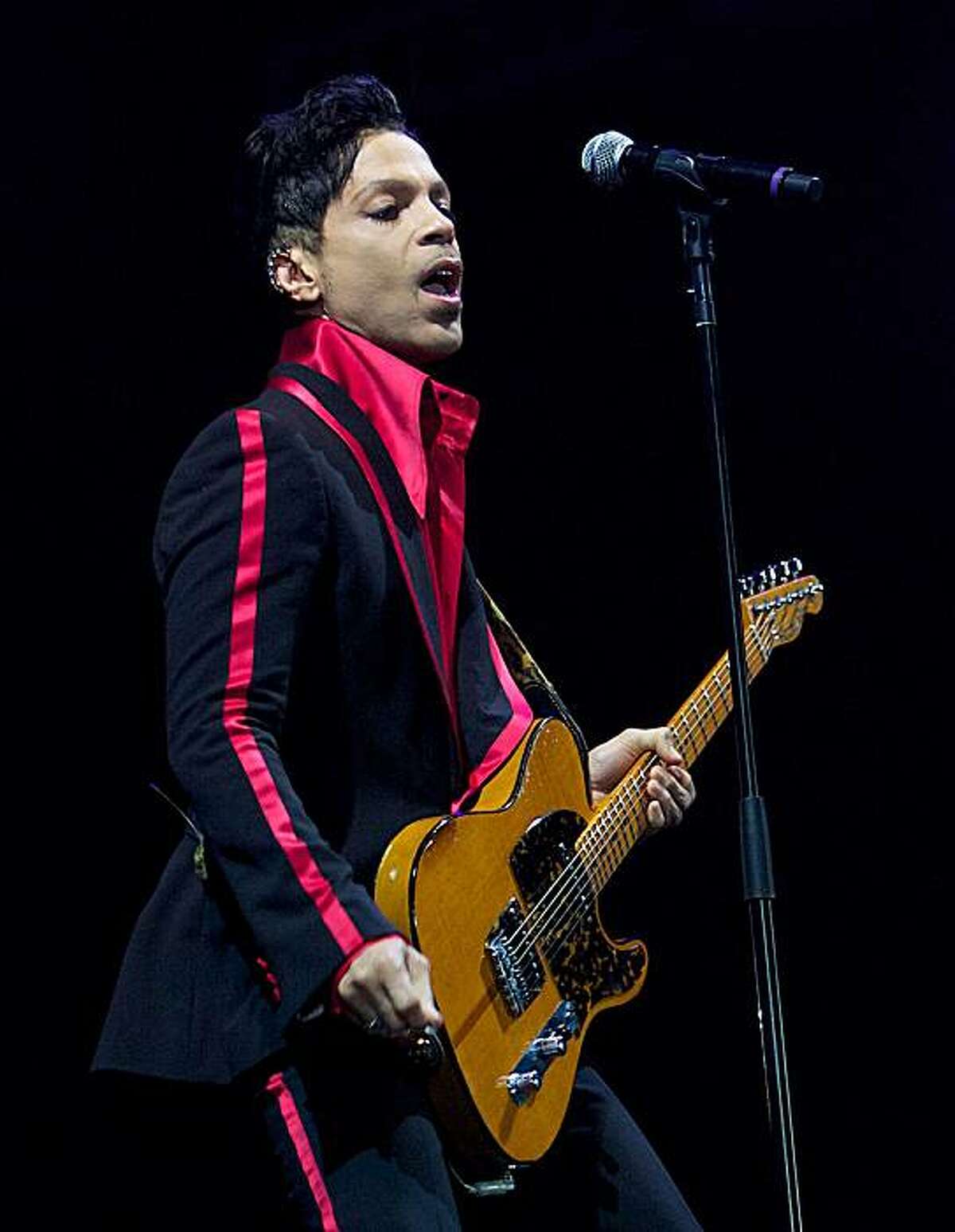 FILE - In this Nov. 14, 2010 file photo, musician Prince performs in Yas Island, on the final night of the F1 motor race meeting in Abu Dhabi, United Arab Emirates. The Prince concert set for Super Bowl weekend as a fundraiser for the art foundation founded by George Michael and his longtime partner, Kenny Goss, was a bust. The concert, recently moved from a tent in downtown Dallas, to a hotel just north of the city never materialized Friday, Feb. 4, 2011. An official with the Intercontinental Hotel confirmed that Prince never performed.