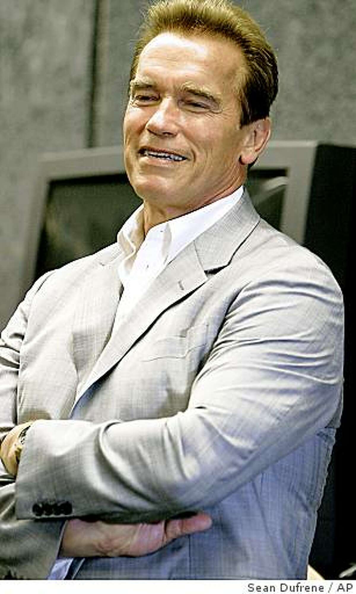 Caption History: California Gov. Arnold Schwarzenegger listens to the Carlsbad High School band's rendition of "Secret Agent Man" during a visit to the school, Friday, Aug. 11, 2006, in Carlsbad, Calif. Schwarzenegger visited the northern San Diego County school in an effort to highlight the school's arts, music and physical education program, something he says is needed in all California schools. Schwarzenegger has put aside $645 million to fund those kinds of programs