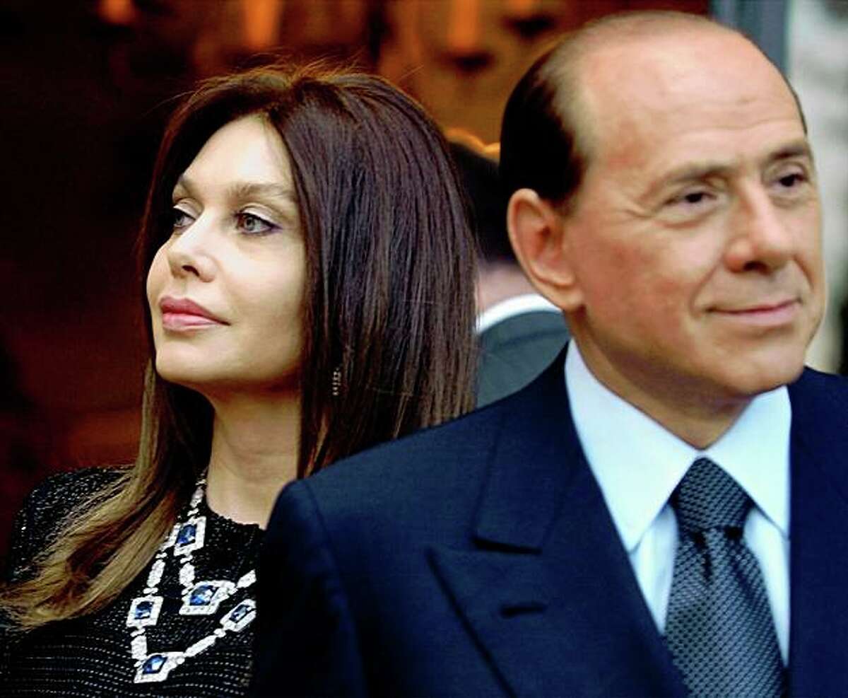 FILE - In this Friday June 24, 2004 file photo, Italian premier Silvio Berlusconi, right, and his wife Veronica Lario wait for President George W. Bush and first lady Laura Bush at the Villa Madama residence for a social dinner, in Rome. On Sunday, May 3, 2009 two Italian newspapers reported that Premier Silvio Berlusconi's wife is seeking a divorce. La Stampa and La Repubblica dailies say Veronica Lario had retained a divorce attorney to begin the process of legal separation and divorce. Berlusconi's office said it had no comment Sunday. (AP Photo/Susan Walsh, File)