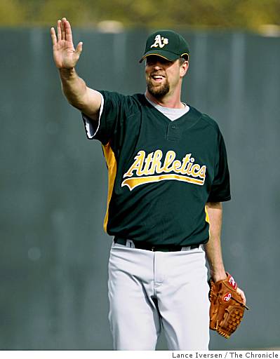 Former Oakland Athletics pitcher Dallas Braden wears a jersey of former San  Francisco Giants pitcher Tim Lincecum before a baseball game between the  Athletics and the Giants in Oakland, Calif., Friday, Aug.